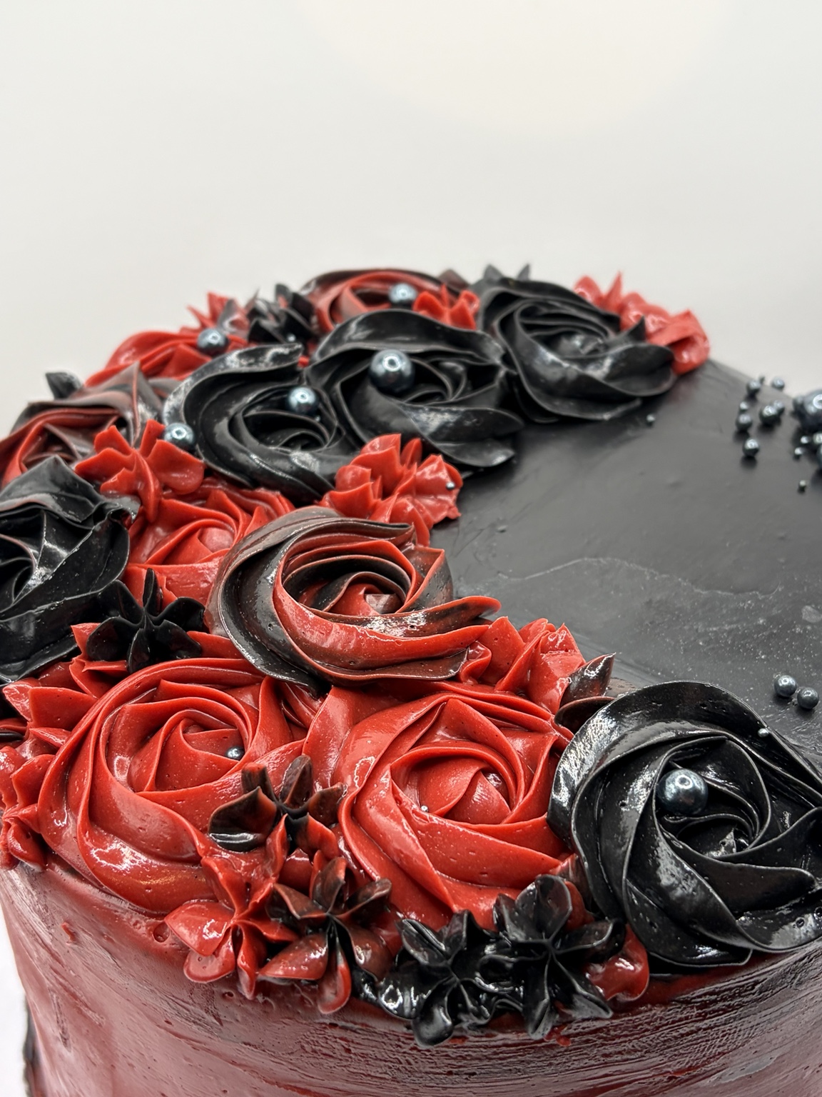 Close-up of black and red buttercream roses