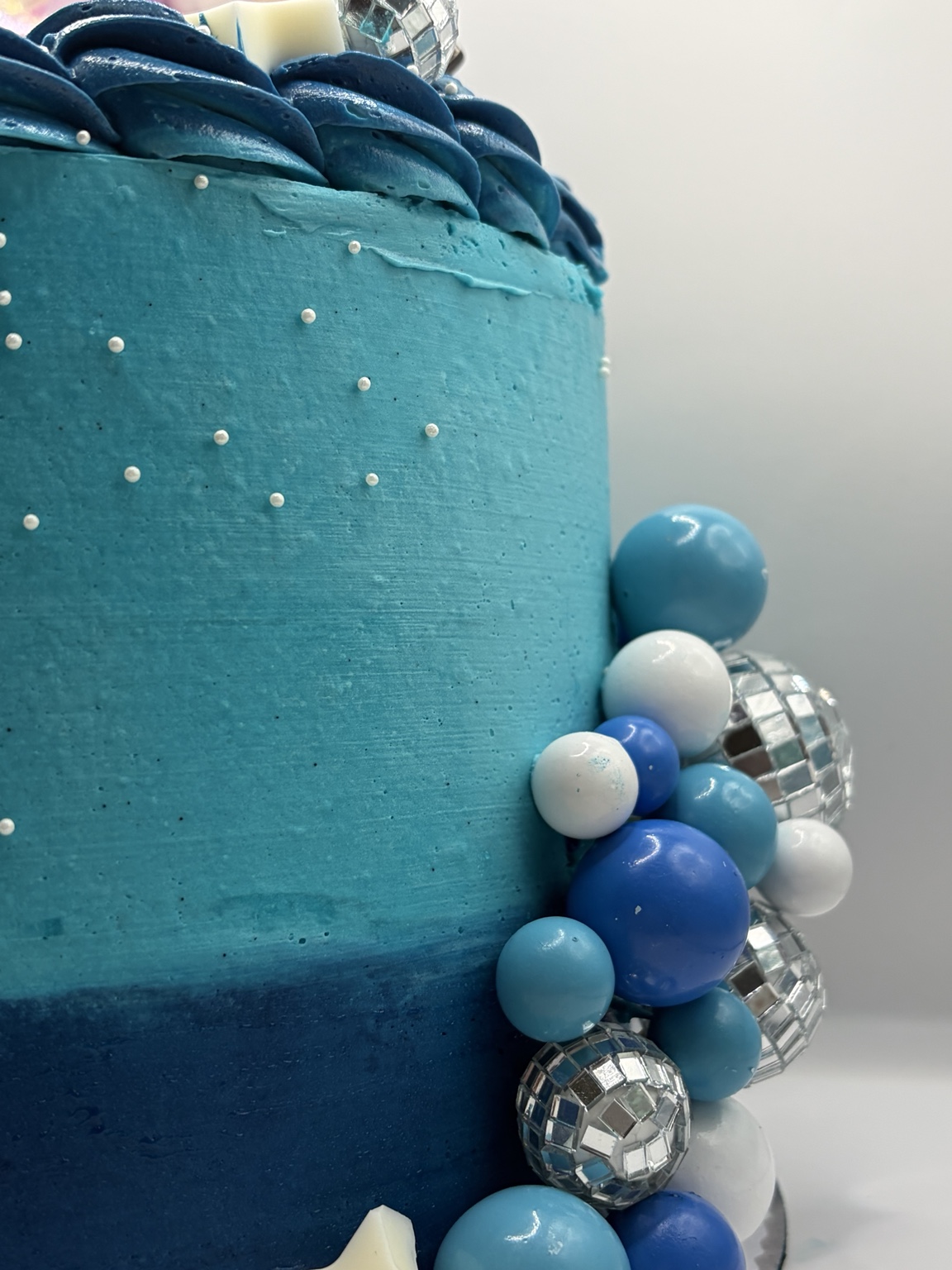 Blue cake detail with disco balls and sugar pearls